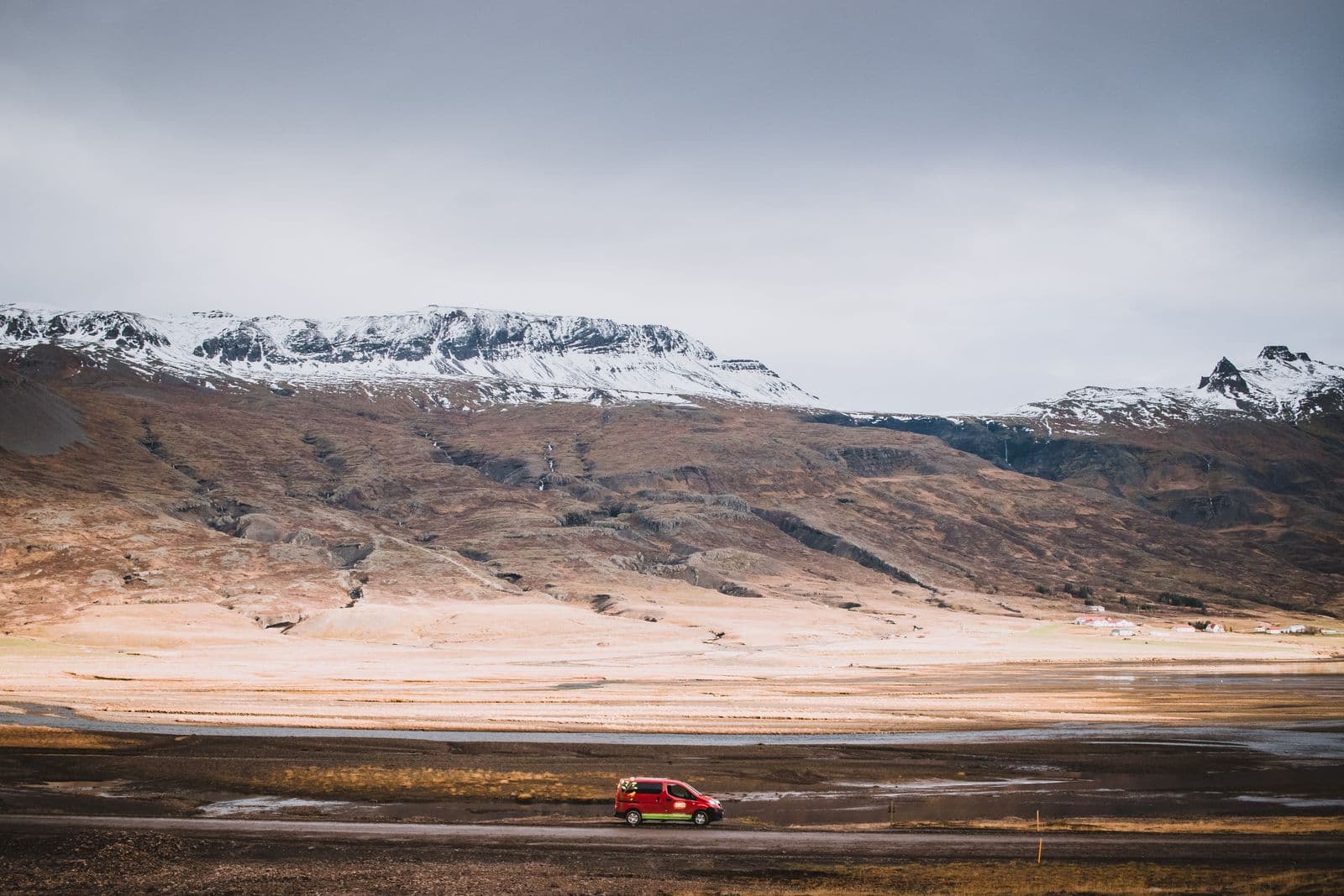 A small city rental car on a paved Icelandic road
